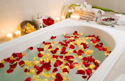 Spa treatment bathtub with floating rose petals